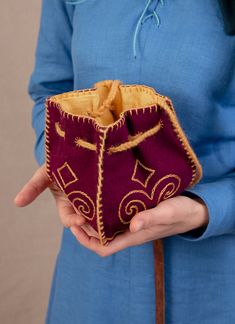 a woman holding a small purse in her hands