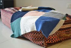 a multicolored blanket sitting on the floor