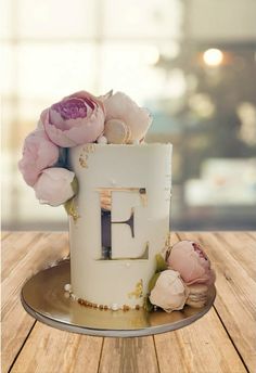 there is a cake with flowers on the top and letters in the middle that spell out f