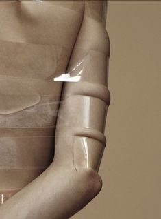 a plastic mannequin is wrapped in clear tape to show the skin on it's body