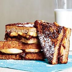 three pieces of french toast stacked on top of each other next to a glass of milk