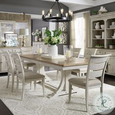 a dining room table with chairs and a chandelier