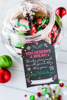 a jar filled with christmas candies on top of a table