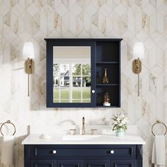 a bathroom vanity with blue cabinets and white marble counter top, along with a mirror on the wall