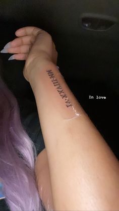 a woman's arm with a tattoo that reads, in love