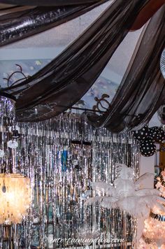 a room filled with lots of different types of decorations and lights hanging from the ceiling