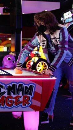 two people in costumes are playing an arcade game