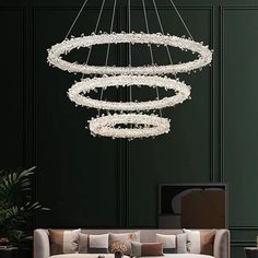 a living room filled with furniture and a large chandelier hanging from the ceiling