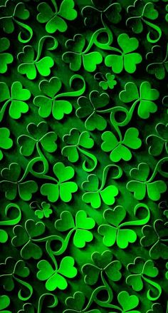 green shamrocks on a black background for st patrick's day wallpaper or backdrop