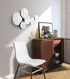 a white chair sitting in front of a wooden cabinet