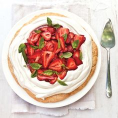 there is a pie with strawberries on it and a fork next to the pie