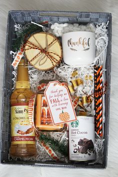 a gift box filled with alcohol, cookies and other holiday treats for someone to enjoy