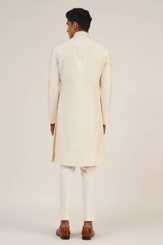 Ivory full sleeve sherwani with round high neckline. - Aza Fashions Classic Fitted Sherwani With Naqshi Detailing, Classic Sherwani With Naqshi For Wedding, Classic Cream Sherwani For Festive Occasions, Classic Long Sleeve Sherwani With Naqshi, Fitted Cream Kurta With Naqshi Detailing, Long Sleeve Cream Sherwani With Naqshi, Off White Long Sleeve Formal Kurta, Classic Cream Nehru Jacket For Wedding, Formal Cream Sherwani With Long Sleeves