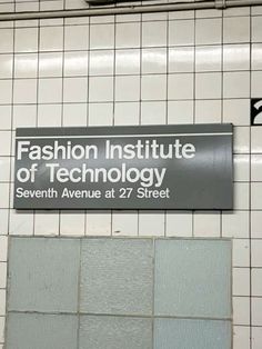 a sign that says fashion institute of technology on the side of a wall in a subway station