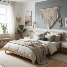 a large bed sitting in a bedroom on top of a wooden floor next to a window