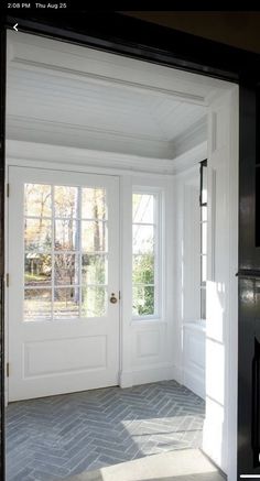 an open door leading into a white room