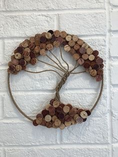 a white brick wall with a circle made out of wine corks hanging on it's side