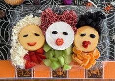 some kind of food with faces on it and fruit in the shape of people's heads