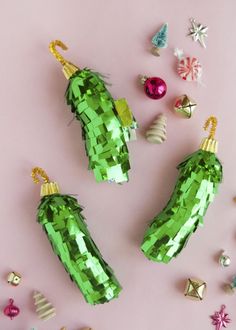 green christmas decorations on a pink background