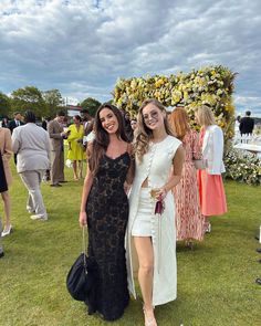 two women standing next to each other on a field