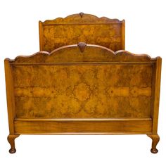 an antique wooden bed frame with carved details