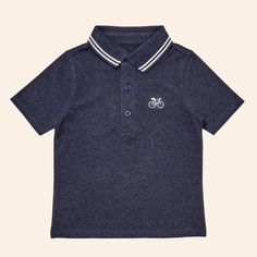 The Andre polo shirt is comfortable enough to play in all day but can also be worn for perhaps one of life’s dressier moments - think school picture day or brunch with grandma. The Andre polo shirt is made from our super soft pique knit and features a classic rib collar and cute embroidery at the chest. 93% Organic Cotton, 2% Recycled Polyester, 5% Spandex Blue Polo Collar Top For School, Preppy Cotton Polo Shirt For School, Summer Cotton Polo Shirt For School, Sporty Cotton Polo Shirt For School, Summer School Cotton Polo Shirt, Collared T-shirt For School In Spring, Spring School T-shirt With Collar, Preppy Collared Cotton Tops, Preppy Cotton Collared Tops