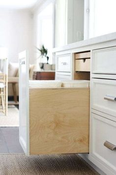 an open drawer in the middle of a kitchen