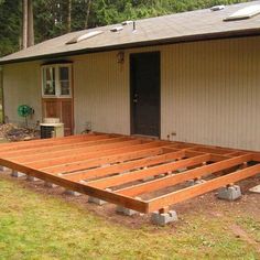 a wooden deck in front of a house