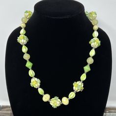 "🌼 An amazing piece of mid century jewelry from Western Germany.  Green and yellow hard plastic molded beads, in various shapes, with flower cluster bead accents.  An unusual and stunning statement piece. 🌼 Measures: 21 1/2\" long.   🌼 Condition: very good, no missing or loose beads, clasp works well. Please see all photos for complete details. For more vintage jewelry/boxes in my shop, please visit: https://www.etsy.com/shop/TheVintageDaisyVault?ref=seller-platform-mcnav§ion_id=25440304" Retro Yellow Flower Jewelry, Retro Yellow Flower-shaped Jewelry, Yellow Flower-shaped Retro Jewelry, Vintage Flower Shaped Beaded Necklaces, Vintage Flower-shaped Beaded Necklaces, Vintage Flower Beaded Necklaces, Vintage Polished Yellow Beads Jewelry, Vintage Yellow Necklace With Colorful Beads, Vintage Yellow Jewelry With Polished Beads