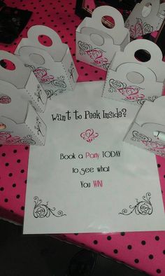 a table topped with lots of white bags and pink polka doted tables cloths