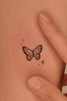 a small butterfly tattoo on the stomach