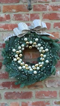 a wreath hanging on the side of a brick wall