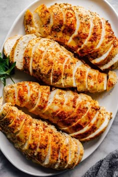 sliced chicken on a white plate with parsley