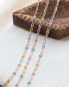 Length: 4 feet (unless otherwise listed in the drop down menu) Enamel footage chain (unfinished chain) 18k gold plated. Base: brass. Finish: 18k gold. Links measure approximately 6mm x 3mm Colors: Shades of purple/pink/blue/turquoise/orange Style ID: GP105 Suggested jump ring for permanent jewelry: JR8 - www.etsy.com/listing/1467647210 More From Our Shop  bayandstew.etsy.com New items added weekly. Stay updated on Instagram: @bayandstew About Bay & Stew Supplies We are your go to shop for hand stamping supplies, engraving supplies, permanent jewelry supplies and wholesale/bulk jewelry supplies. USA small business & female owned company. Multicolor Link Chain Jewelry, Multicolor Beaded Chain Necklace For Gift, Multicolor Link Jewelry With Adjustable Chain, Multicolor Adjustable Chain Link Necklace, Multicolor Paperclip Chain Jewelry For Gifts, Multicolor Paperclip Chain Necklace As Gift, Multicolor Paperclip Chain Necklace Gift, Multicolor Paperclip Chain Necklace For Gift, Colorful Chain Jewelry As Gift