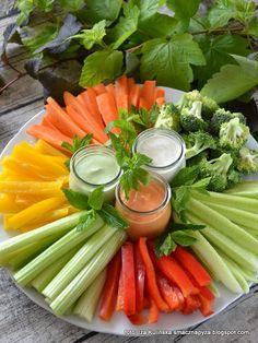 carrots, celery, broccoli and dip on a plate