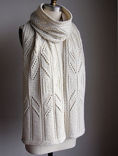 a white knitted scarf on a mannequin