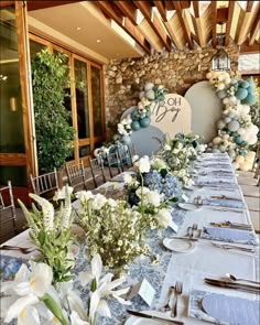 a table set up with flowers and place settings