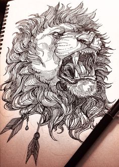 a drawing of a lion's head with feathers on it and a pen next to it