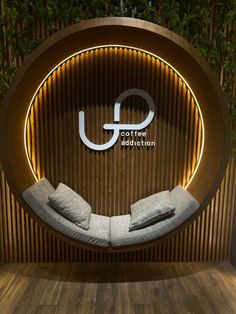 an indoor spa room with wooden walls and circular seating area, lighted by led lights