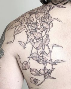 the back of a man's shoulder with flowers on it