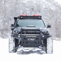 a toyota truck driving through the snow