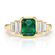 This elegant and timeless Caroline ring by Single Stone is set in 18k yellow gold, featuring an emerald cut Zambian emerald and accompanied by two baguette diamond accents on each shoulder. • 18k yellow gold • 1.46ct Zambian Emerald & 0.66tcw Baguette Diamonds • Band width: 2mm • In stock in size 6. Additional sizes are special ordered or resized upon request and availability, please allow 6-8 weeks for delivery. Baguette Diamond Band, Single Stone Ring, Diamond Cocktail Ring, Zambian Emerald, Shine Bright Like A Diamond, Diamond Cocktail Rings, Engagement Ring Sizes, Alternative Engagement Rings, Single Stone