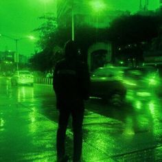 a man standing in the rain at night