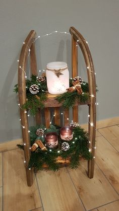 a wooden stand with candles and decorations on it