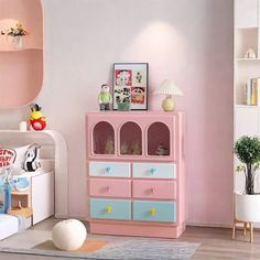 a child's bedroom with pink and blue furniture