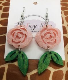 This listing is for a Pink Rose Resin earrings with a leaf dangling. Ear wire closure. Pink Flower Shaped Pierced Earrings, Pink Flower Earrings With Rose Design, Rose Flower-shaped Earrings With Rose Design, Pink Rose Design Drop Earrings, Pink Dangle Jewelry With Rose Design, Pink Rose Design Dangle Jewelry, Handmade Rose Dangle Earrings, Handmade Rose Drop Earrings, Rose Colored Dangle Jewelry With Rose Design