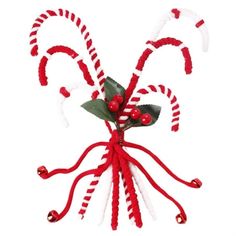 a red and white candy cane decoration on a white background, with holly berries in the center