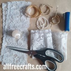 lace, scissors and other crafting supplies laid out on a table