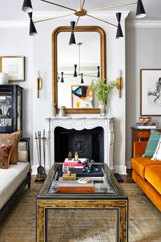 a living room filled with furniture and a large mirror on the wall over a fire place