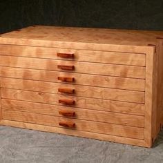 a wooden dresser with five drawers on it